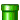 a green bottle with a white cap is sitting on a white surface .