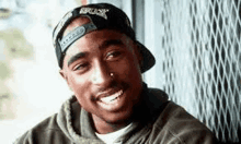 a close up of a man wearing a hat and a bandana .