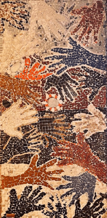 a mosaic shows a group of hands reaching out towards each other