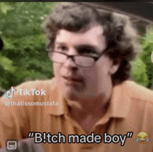 a man with glasses says " bitch made boy " in a tik tok video