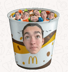 a mcdonald 's cup has a man 's face on it