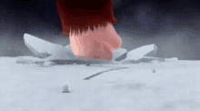 a hand is breaking a piece of ice in the snow