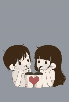 a boy and a girl drinking from cups with straws that have hearts on them