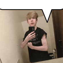 a young man taking a picture of himself in a bathroom