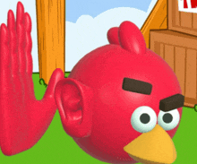 a red angry bird with a yellow beak is giving a high five