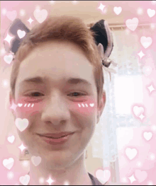 a young man with a cat ear on his head with pink hearts around his face