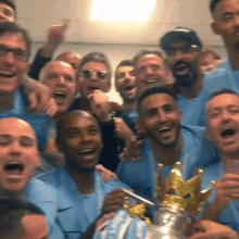 a group of men are posing for a picture while holding a trophy that says ' league ' on it