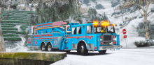 a blue fire truck is parked on the side of the road in the snow