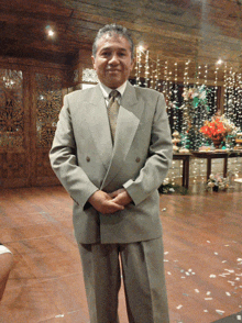 a man in a suit and tie is standing in front of a wooden door