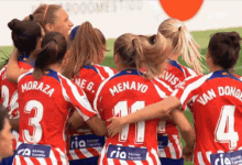 a group of female soccer players wearing red and white uniforms with the names moraza and menayo on the back