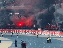 a stadium with a banner that says emblematique super champion d' afrique on it