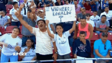 a group of people holding a sign that says who needs ronaldo