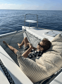 a person is laying on a bean bag chair on a boat