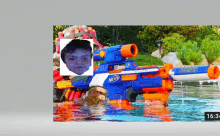 a nerf rifle with a picture of a boy in the background