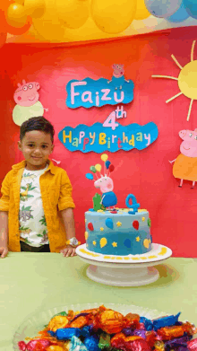 a little boy stands in front of a birthday cake with a sign that says faizu 4th happy birthday