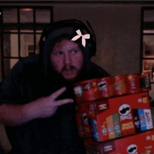 a man holding a stack of pringles chips