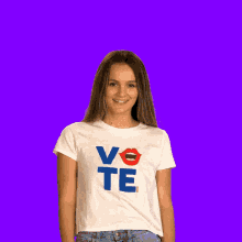 a woman wearing a t-shirt that says vote