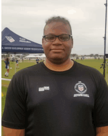 a man wearing a shirt that says u.s. soccer development academy on it