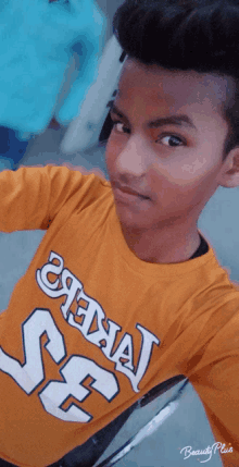 a young boy wearing a yellow shirt that says chennai on it