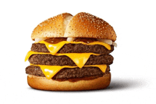 a triple cheeseburger with a bun and sesame seeds