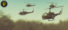 three military helicopters are flying in a formation with a yellow shield that says 1st armored division