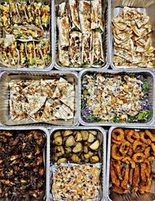 a variety of food in aluminum foil containers