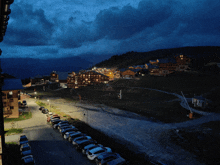 a row of cars are parked in front of a ski resort