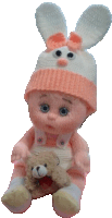 a pink and white knitted doll with bunny ears and a teddy bear