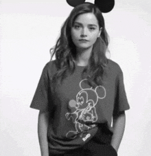 a woman wearing mickey mouse ears and a mickey mouse shirt