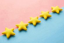 five yellow stars are lined up on a blue and pink background