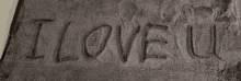 the word i love u is carved into a gray cloth