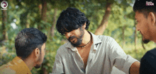 a man with a beard is talking to two other men with eagle team written on the bottom of the screen