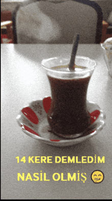 a cup of coffee sits on a saucer with the words 14 kere demledim nasil olmis above it