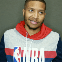 a man wearing a hoodie with the nba logo on it