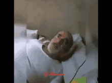 a man with a beard is laying in a hospital bed