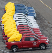 a row of red , white , and blue trucks parked next to each other .