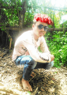 a young man with red hair wearing sunglasses and a shirt that says ' a ' on it