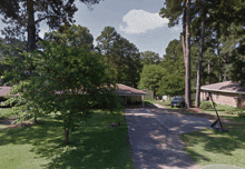 a car is parked in the driveway of a house in a residential area