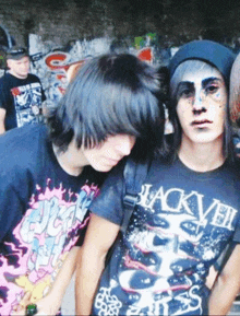 two boys are posing for a picture and one of them is wearing a shirt that says jackveil