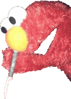 elmo from sesame street is holding a microphone in its mouth