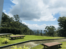 a fenced in area with a view of a mountain and trees