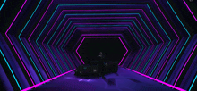 a man standing next to a car in a purple tunnel