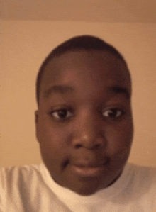 a close up of a person 's face with a white shirt