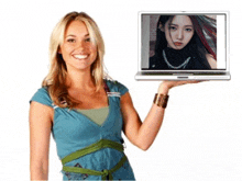 a woman is holding a laptop with a picture of a woman on the screen