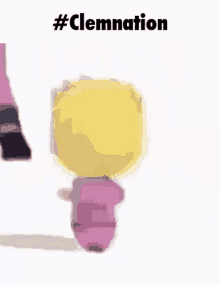 a cartoon character with a yellow ball on his head is standing next to a person .