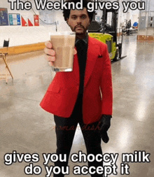 a man in a red suit is holding a glass of milk