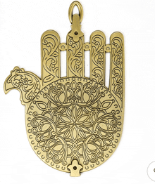 a brass hamsa hand with a floral design