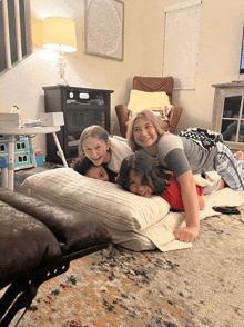 a group of children are laying on their backs on a rug