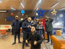 a group of young people are posing for a picture in a living room .