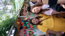 a woman in a yellow shirt stands next to another woman in a pink shirt